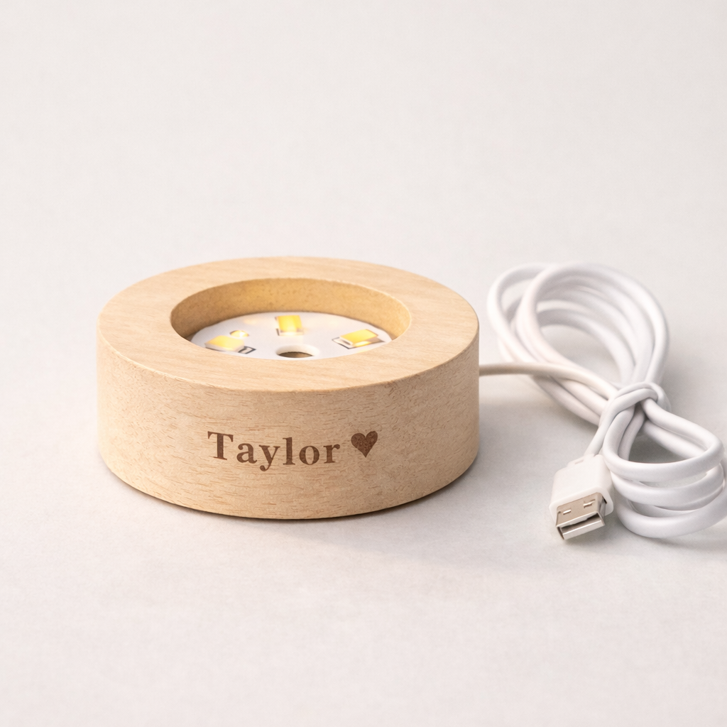 Wooden light stand with 'Taylor' engraving on a white background